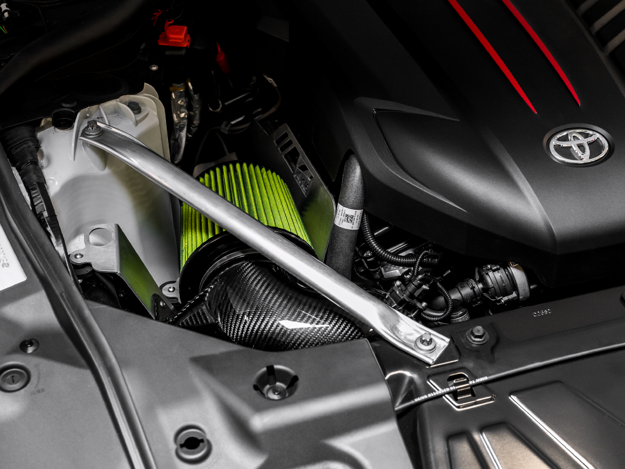 AWE Tuning 2020+ Toyota GR Supra S-FLO Carbon Intake for the MK5 Toyota Supra GR A90 MKV - Product Overview mounted in engine bay front/left view (facing the vehicle)